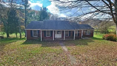 Photo of 3-bedroom, 2-bathroom brick ranch situated on a 3.8 acre mostly level lot. $74,900
